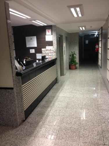 a lobby of a hotel with a reception counter at Soneca Plaza Hotel in Sao Paulo