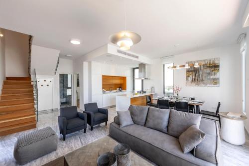 a living room with a couch and a kitchen at Villa Beach Heaven(Laurus 1), walking distance to the beach in Paphos