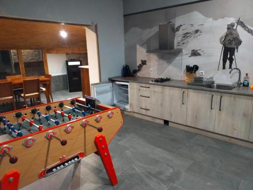 a kitchen with a game board in the middle of a kitchen at Magic Borda Cremat HUT4-5018 in La Massana