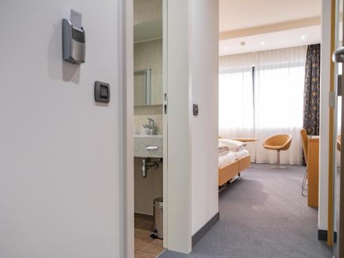 a hospital room with a bed and a window at Hotel Coronado in Mendrisio