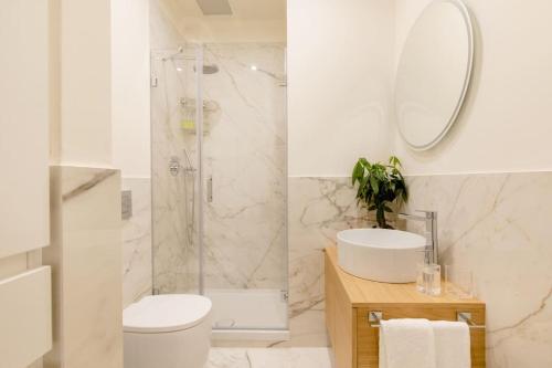 a bathroom with a shower and a toilet and a sink at Duomo Luxury Home with view in Florence