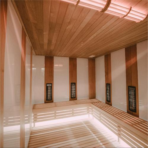 a empty room with a wooden ceiling and windows at Apartman Pegasus in Vrnjačka Banja