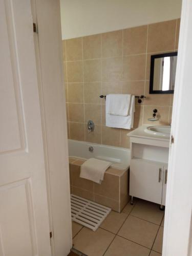a bathroom with a bath tub and a sink at Innes Road Durban Accommodation Private Double Room with Private Bathroom in Durban