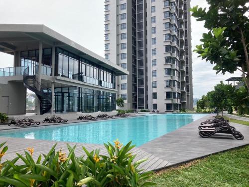 a large building with a swimming pool in front of a building at Astoria Ampang By Grabstay in Kuala Lumpur