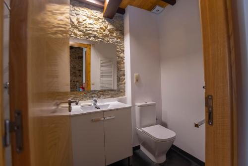 a bathroom with a sink and a toilet at Casa Jovellanos de Casas Das Figueiras en Ría Eo-Ribadeo in Castropol