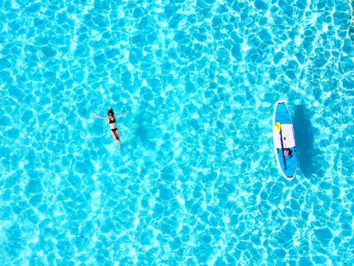two people on surfboards in a pool of water at Hotel Santa Barbara Miyakojima Resort in Miyako-jima