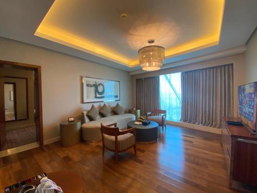 a living room with a couch and a table at Grand Millennium Sulaimani in As Sulaymānīyah