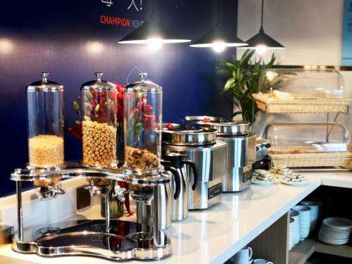 a kitchen counter with food in glass jars at Holiday Inn Express Qingdao City Center, an IHG Hotel in Qingdao