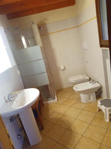a bathroom with a sink and a toilet at Agriturismo Renzano garden apartments in Salò