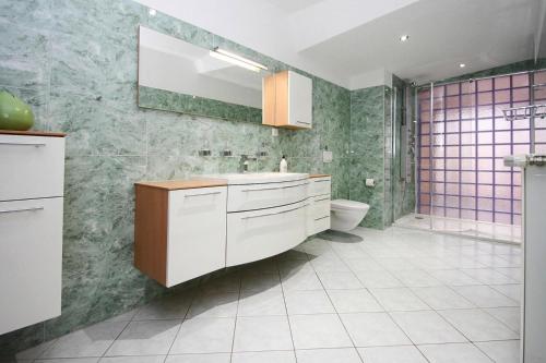 a bathroom with a sink and a toilet at Apartment SL Lounge, Luebben in Lübben