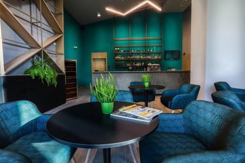 a bar with blue chairs and a table at Magnus Resort in Szczyrk
