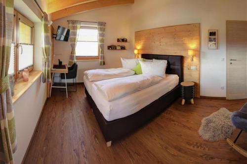 a bedroom with two beds in a room with wooden floors at Bergchalet Falkenstein, Inzell in Inzell