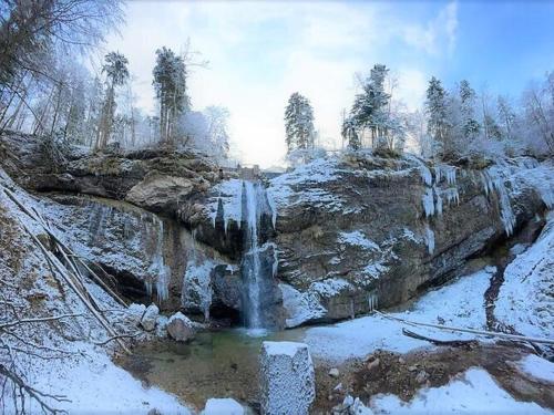 a waterfall in the middle of a snow covered field at Bergchalet Falkenstein, Inzell in Inzell