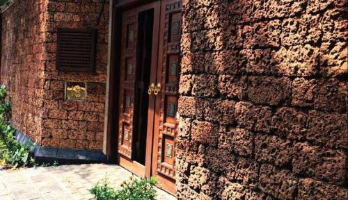 a brick building with a door and a brick wall at Artisan Villa in Colombo