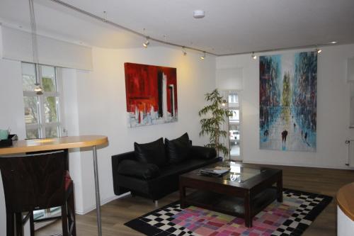 a living room with a couch and a table at Hotel Nüller Hof in Wuppertal