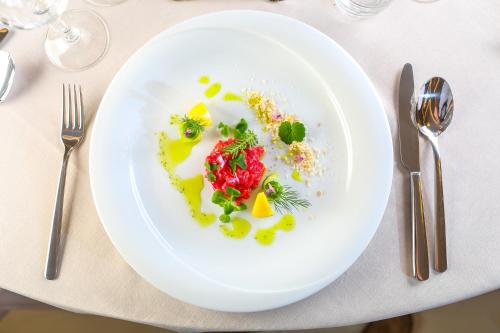 a white plate with food on a table at Magnus Resort in Szczyrk