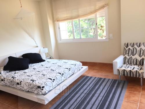 a bedroom with a bed and a window at BarcelonaVacances-Villa Lucia in San Pol de Mar