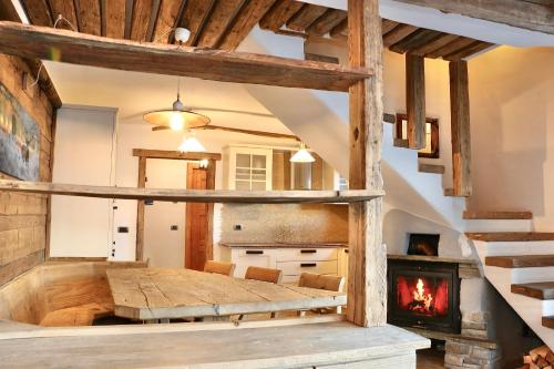 a dining room with a table and a fireplace at Appartamenti Diva in Livigno