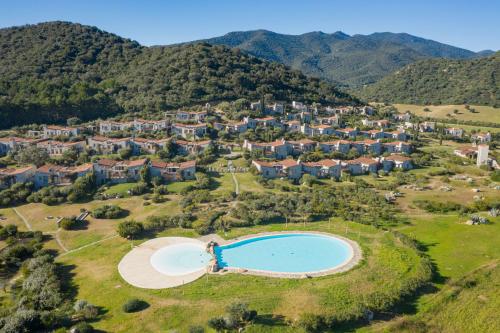 an aerial view of a resort in the mountains at Case Li Conchi Sardegna in Castiadas