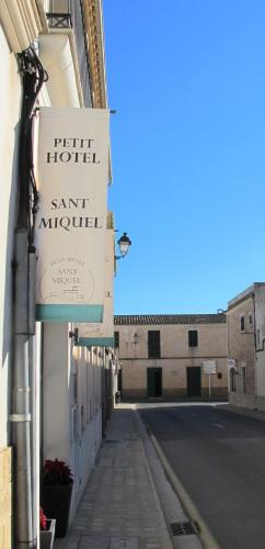 a sign for a hotel on the side of a street at Boutique Hotel Petit Sant Miquel in Calonge