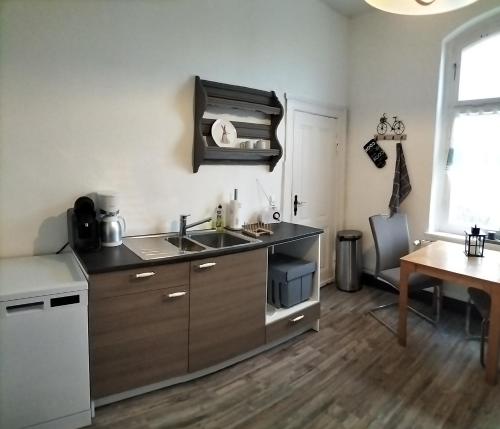 a kitchen with a sink and a counter top at Ferienwohnung im alten Bahnhof in Tribsees