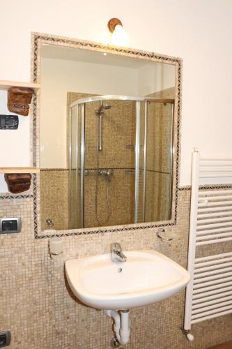 a bathroom with a sink and a mirror at Appartamenti Diva in Livigno