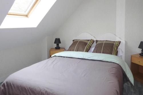 a bedroom with a white bed with a skylight at Holiday Home in Erquy near Sandy Beaches in Erquy