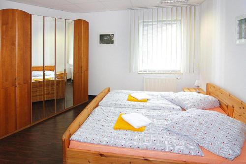 a bedroom with two beds with yellow napkins on them at Apartment in Schwerin with a shared wellness in Schwerin