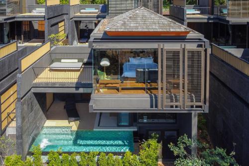 an aerial view of a building with a pool at AKRA Collection Layan in Layan Beach