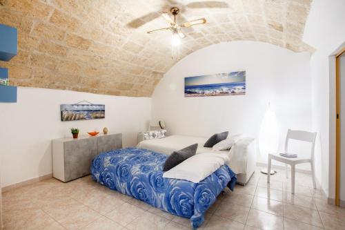a bedroom with a bed and a stone wall at Monopoli Heartbeat - Apartment 200m from Sea in Monopoli