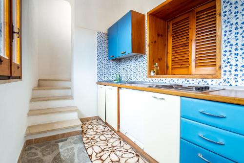 a kitchen with blue cabinets and a sink at Hotel & Spa Relais Freedom Club in Massa Lubrense