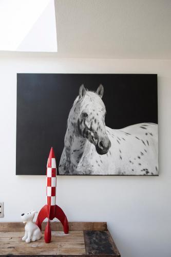a black and white picture of a horse on a wall at Sunshowers Plett in Plettenberg Bay