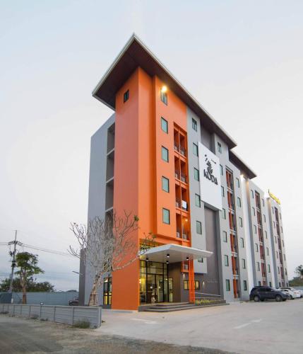 a large building with an orange and gray at Kuda Asia Hotel Bang Saen in Bangsaen