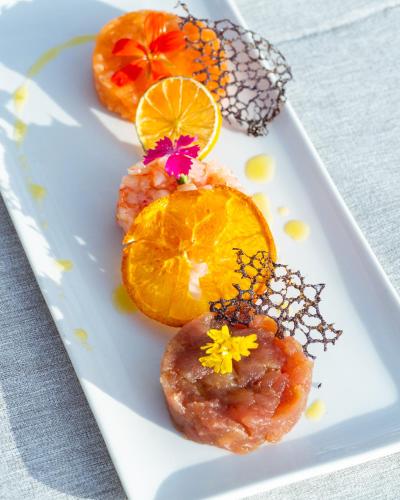 a plate of food with orange slices on a table at Hotel & Spa Relais Freedom Club in Massa Lubrense