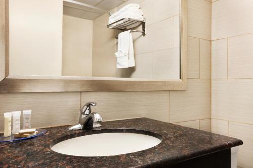 a bathroom with a sink and a mirror at Howard Johnson by Wyndham North Plainfield in North Plainfield