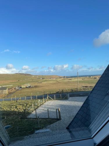 a view of a field from the roof of a house at The Bridge Self Catering in Kilmaluag