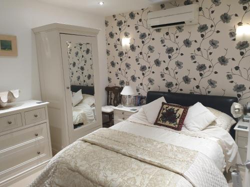 a bedroom with a bed and a large mirror at Best Area Close to Leeds Centre in Leeds