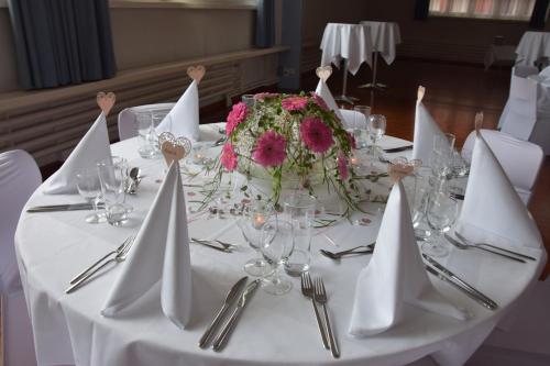 a table with a white table cloth with a cake on it at Hotel Hecht in Rheineck