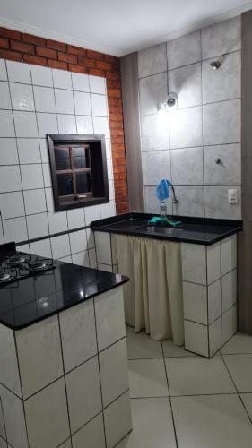 a kitchen with a counter and a sink in it at Nacif's Suites in Rio de Janeiro