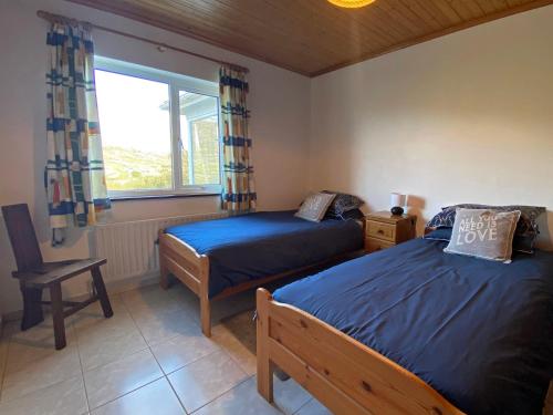 A bed or beds in a room at Cottage 396 - Roundstone