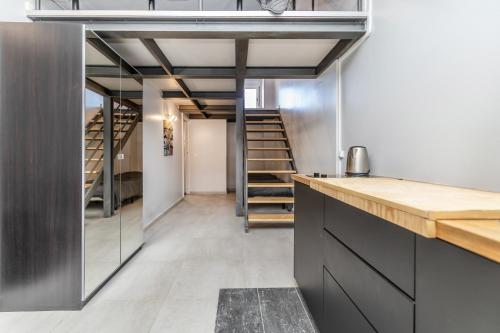 a kitchen with a staircase in the background at Apartamentos Lux Dinastia in Lisbon