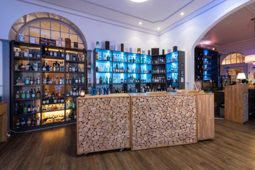 a bar in a room with shelves of alcohol at Hotel Terrace in Engelberg