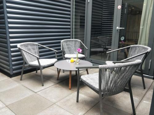 three chairs and a table on a patio at Cityden BoLo District in Amsterdam