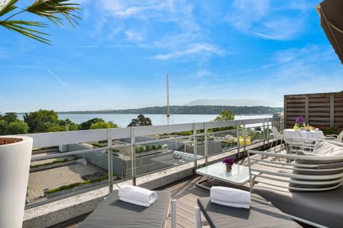 a balcony with a view of the water at N’vY Manotel in Geneva