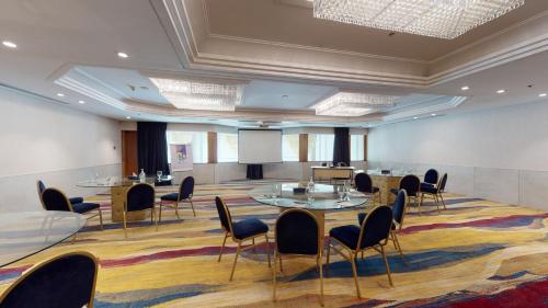 a conference room with tables and chairs and a podium at Ayass Hotel in Amman