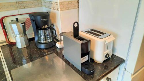 a kitchen counter with a coffee maker and a toaster at Riaño en las Montañas de Carmen in Riaño