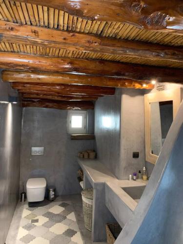 a bathroom with a sink and a toilet at Lydia's house in Révmata