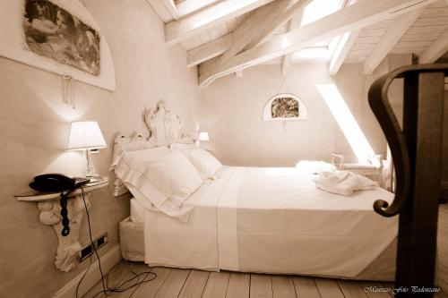 a bedroom with a white bed in a room at Relais La Colombara Spa & Wellness in Travo