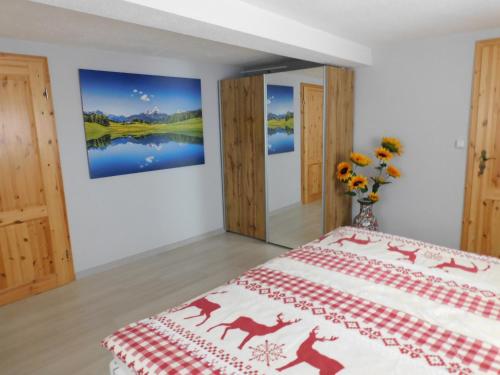 1 dormitorio con 1 cama y una pintura en la pared en Haus Eugen, en Presseck