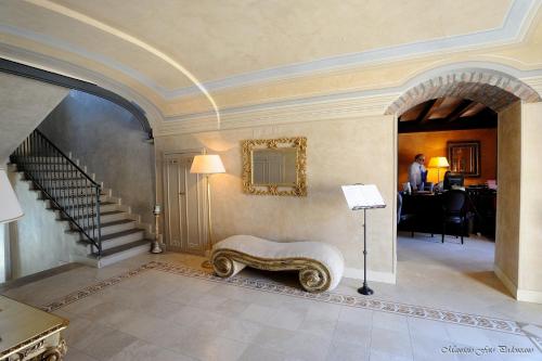 a living room with a staircase and a couch in a house at Relais La Colombara Spa & Wellness in Travo